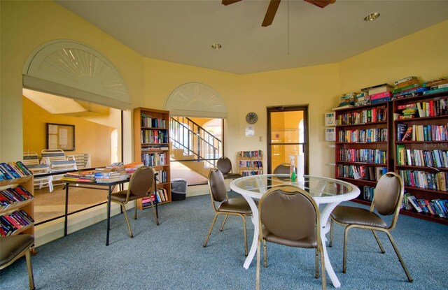 dining space featuring ceiling fan and carpet