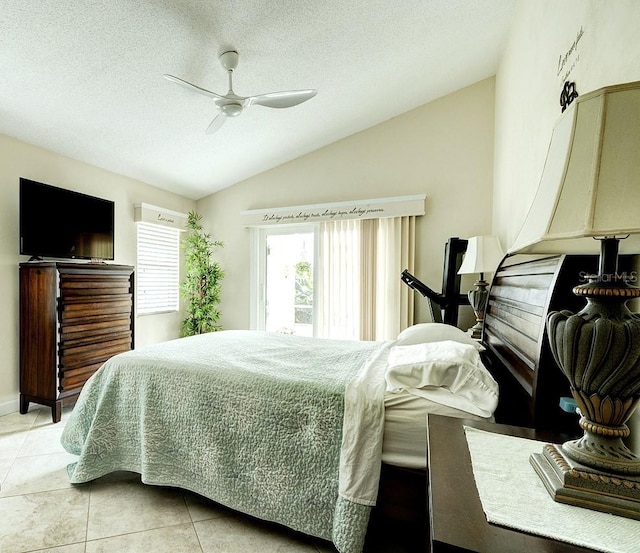 bedroom with light tile patterned flooring, ceiling fan, vaulted ceiling, and a textured ceiling