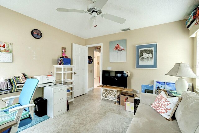 office space featuring ceiling fan, a textured ceiling, and light tile patterned floors