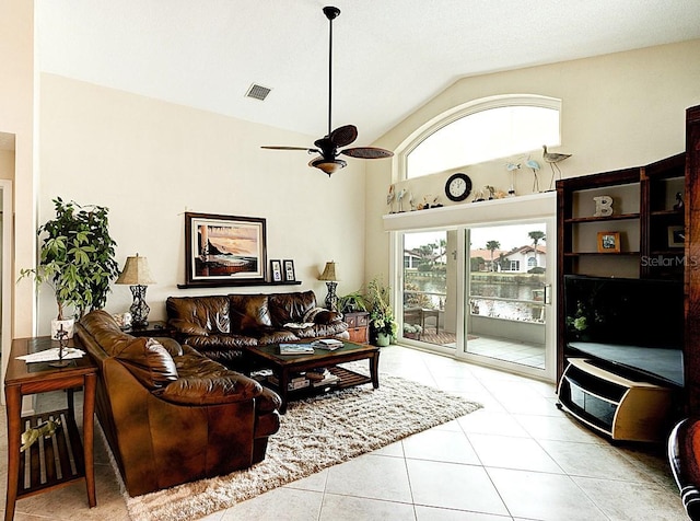 tiled living room with high vaulted ceiling and ceiling fan