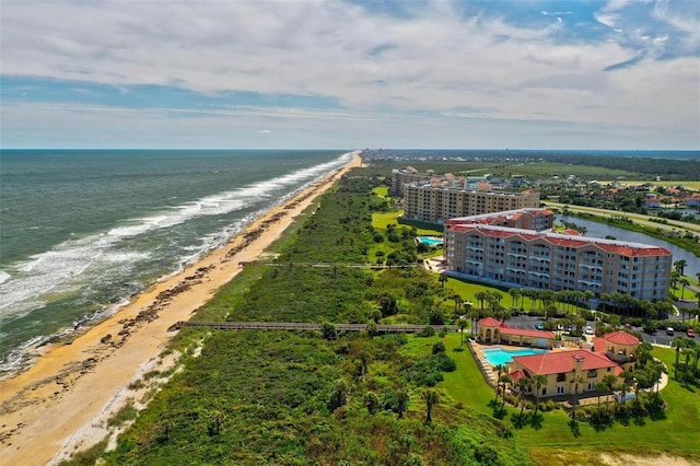 drone / aerial view featuring a water view and a view of the beach