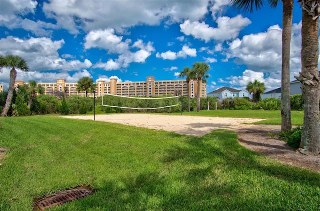 surrounding community featuring a lawn and volleyball court