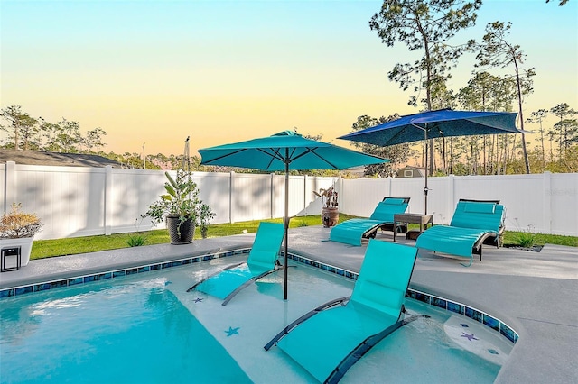 view of pool at dusk