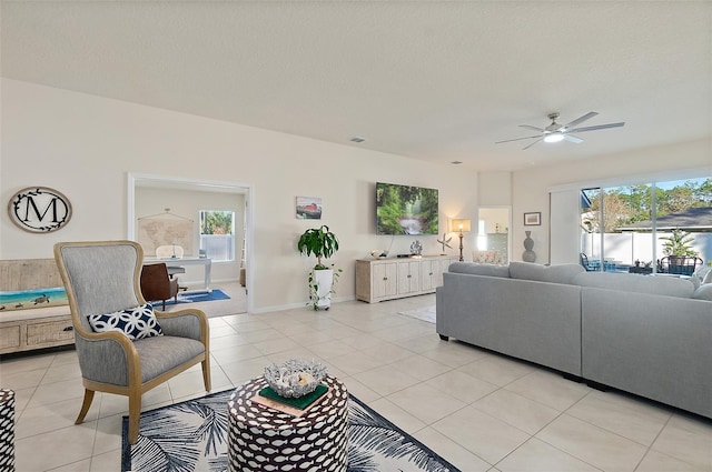 tiled living room featuring ceiling fan and a textured ceiling