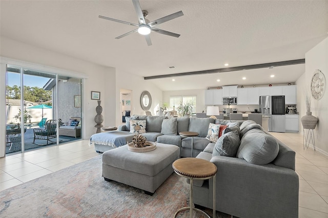 living room featuring a wealth of natural light, beamed ceiling, and light tile patterned floors