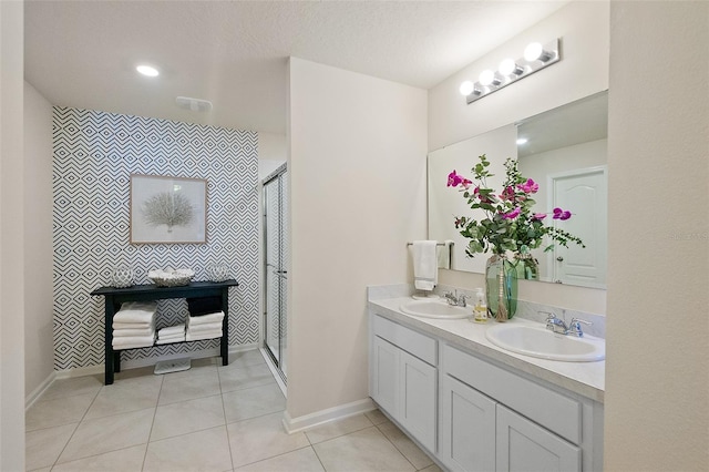 bathroom featuring vanity, tile patterned floors, and walk in shower