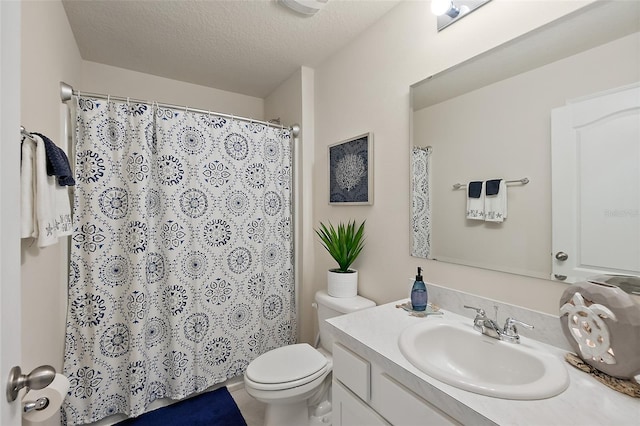 bathroom featuring vanity, a textured ceiling, and toilet