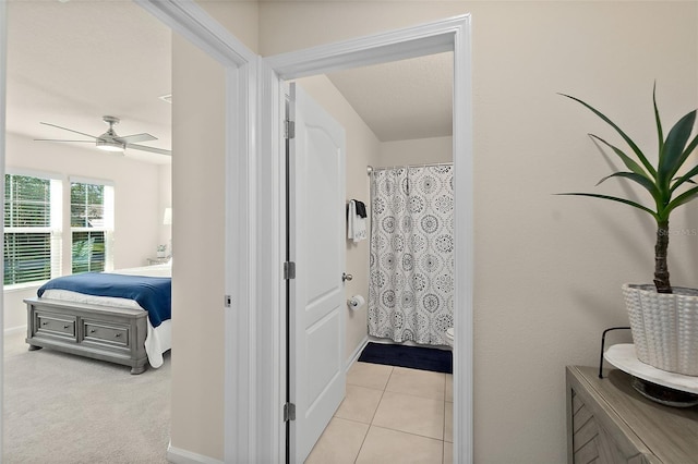 bathroom with tile patterned flooring, a shower with shower curtain, and ceiling fan