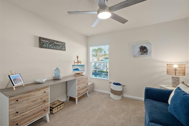 office space featuring ceiling fan and light carpet