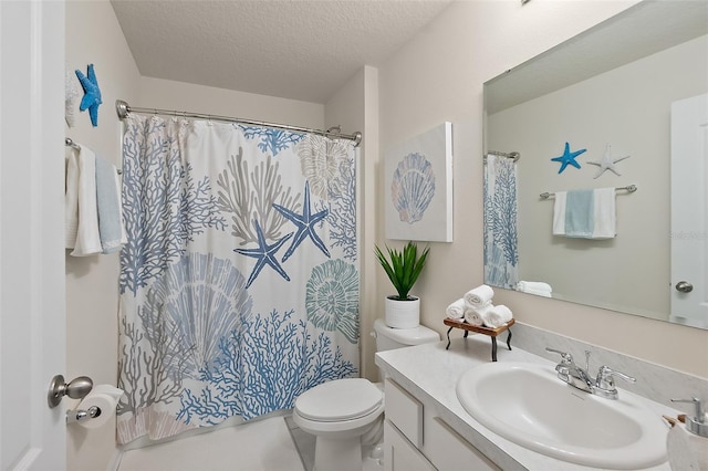 bathroom featuring curtained shower, vanity, a textured ceiling, and toilet