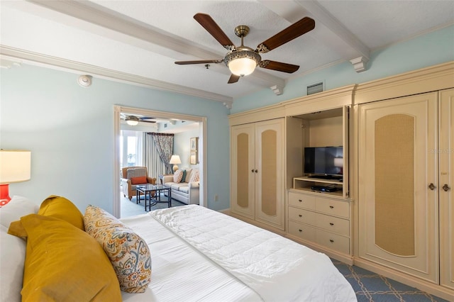 bedroom featuring beamed ceiling, a closet, and ceiling fan
