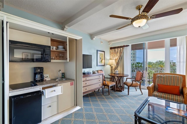 interior space with ceiling fan, sink, beamed ceiling, a textured ceiling, and carpet