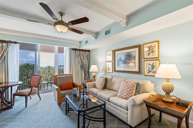 living room with beamed ceiling, ceiling fan, a textured ceiling, and carpet