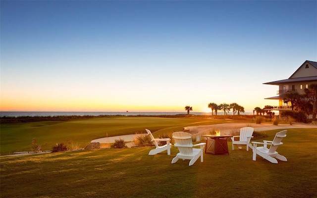 yard at dusk featuring a fire pit