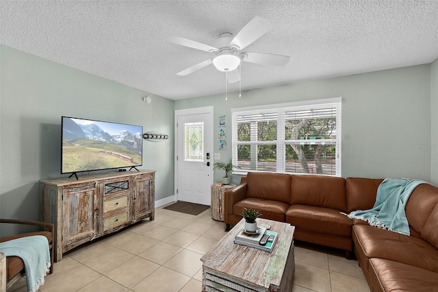 tiled living room featuring a textured ceiling and ceiling fan