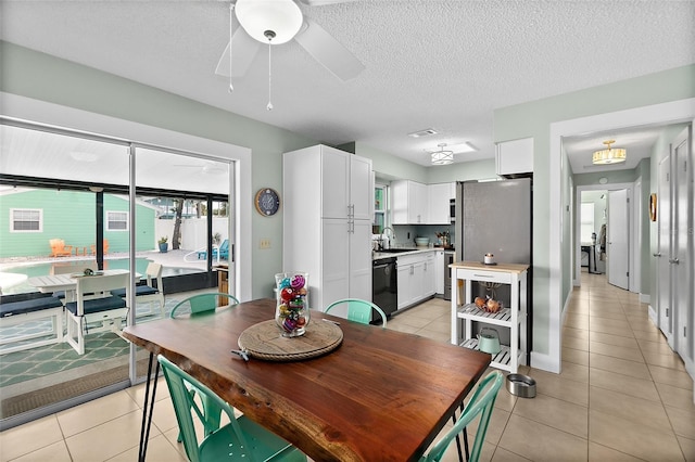 tiled dining room with a textured ceiling, ceiling fan, and sink