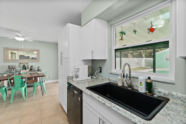 kitchen with dishwasher, a textured ceiling, white cabinets, and sink