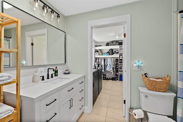 bathroom featuring tile patterned floors, vanity, and toilet