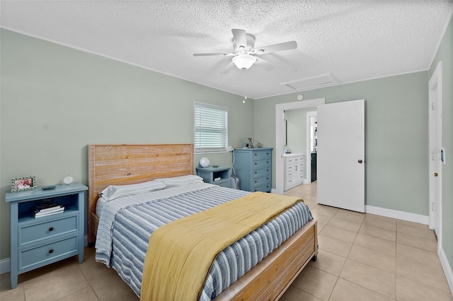 bedroom with ceiling fan, light tile patterned flooring, and a textured ceiling