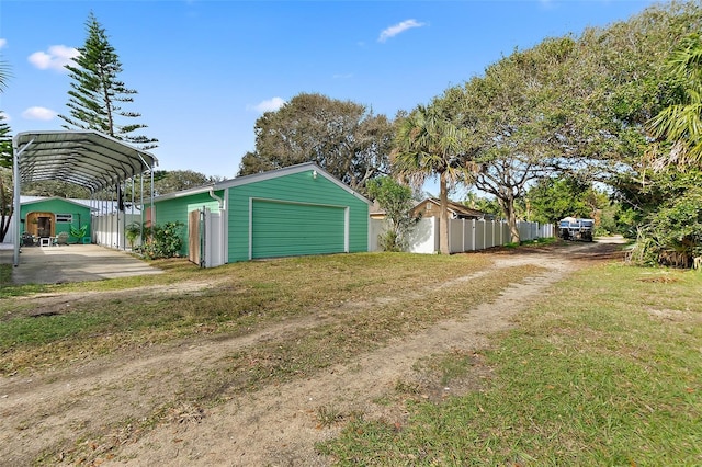 garage featuring a yard and a carport