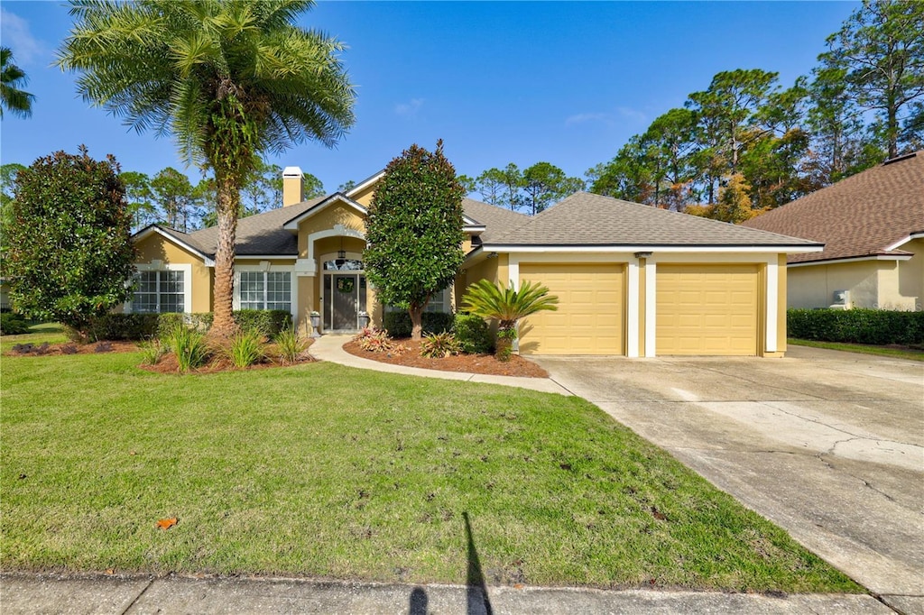 view of front facade with a garage and a front yard