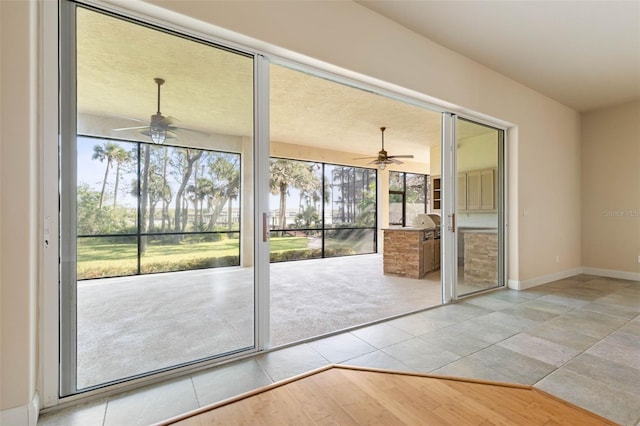 entryway featuring ceiling fan and light tile patterned floors