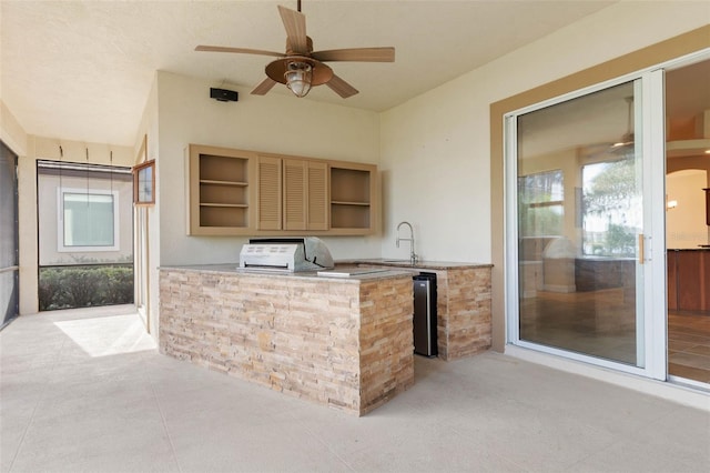 kitchen with light tile patterned flooring, ceiling fan, and sink