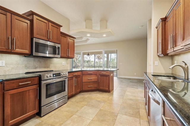 kitchen featuring backsplash, sink, dark stone countertops, light tile patterned flooring, and stainless steel appliances