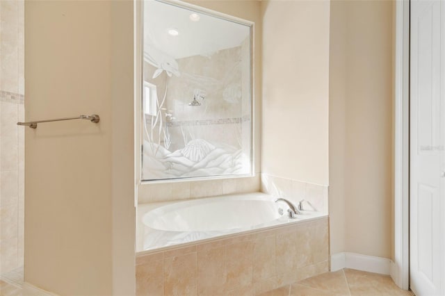 bathroom featuring tile patterned flooring and tiled tub