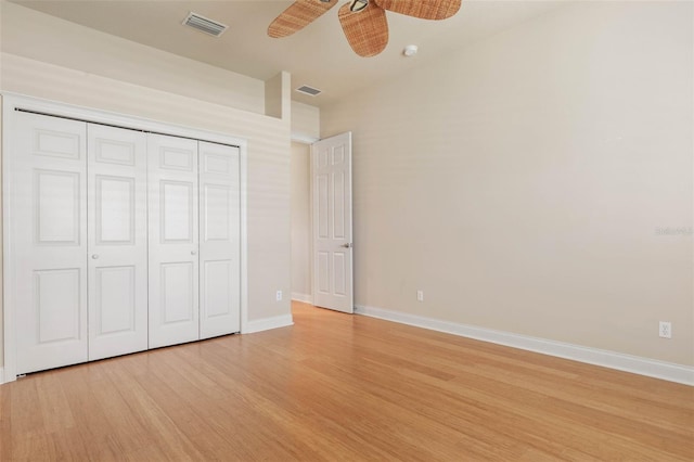 unfurnished bedroom featuring ceiling fan, light wood-type flooring, and a closet