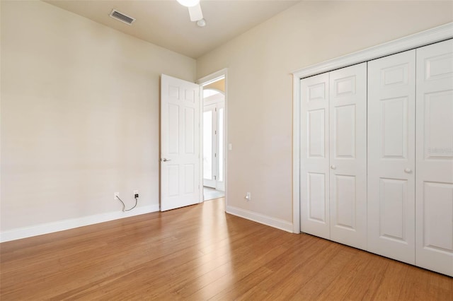 unfurnished bedroom featuring ceiling fan, a closet, and light hardwood / wood-style flooring