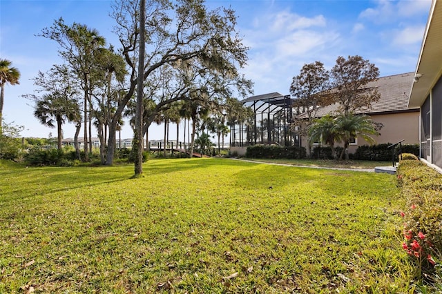 view of yard featuring glass enclosure