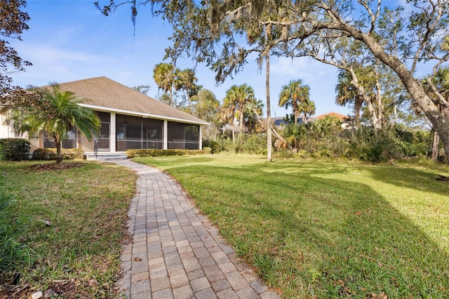 view of yard featuring a sunroom