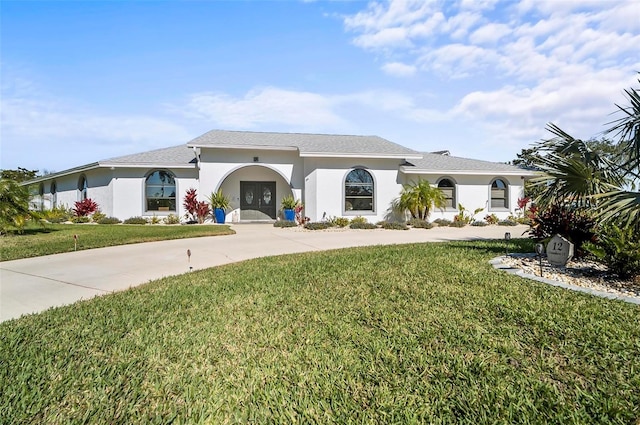 mediterranean / spanish house with a front yard