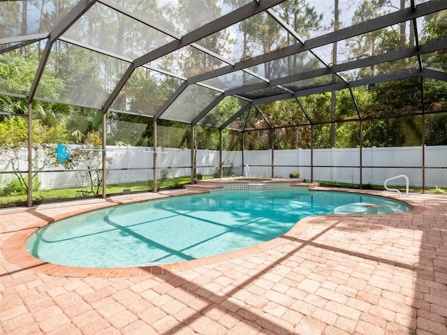 view of pool featuring an in ground hot tub, a patio, and a lanai