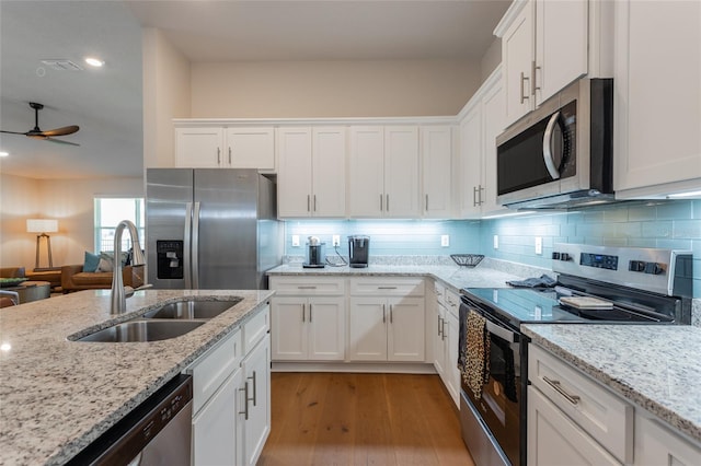 kitchen with ceiling fan, sink, white cabinets, and stainless steel appliances