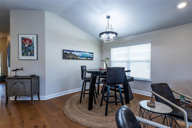 dining room featuring dark hardwood / wood-style flooring and lofted ceiling