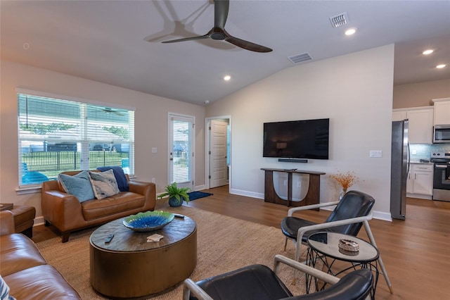 living room featuring wood-type flooring, vaulted ceiling, and ceiling fan