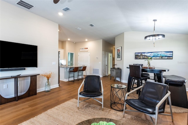 living room featuring hardwood / wood-style floors and vaulted ceiling