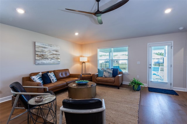 living room featuring ceiling fan and dark hardwood / wood-style flooring