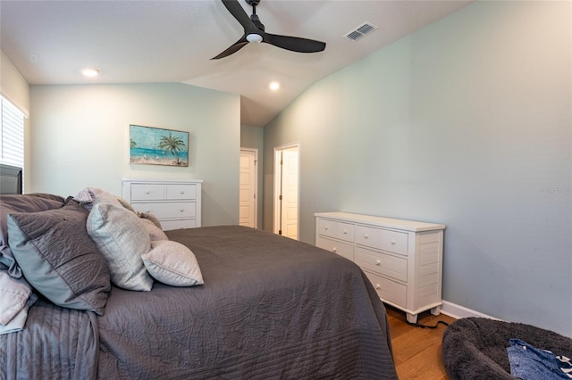 bedroom with hardwood / wood-style floors, vaulted ceiling, and ceiling fan