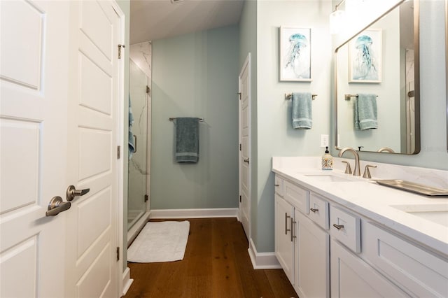 bathroom featuring vanity, an enclosed shower, and wood-type flooring