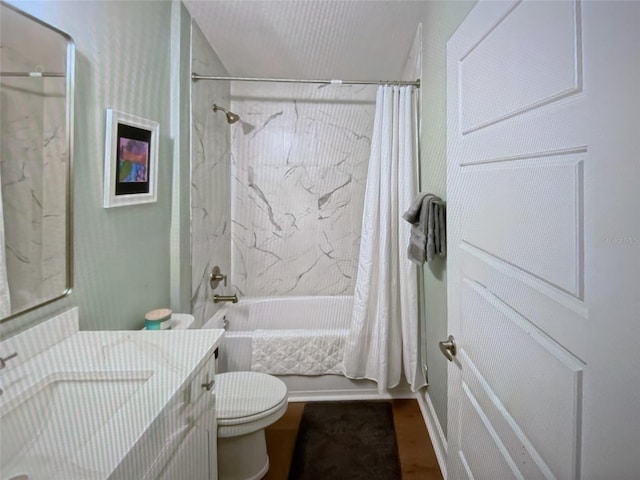 full bathroom with vanity, shower / tub combo, and toilet