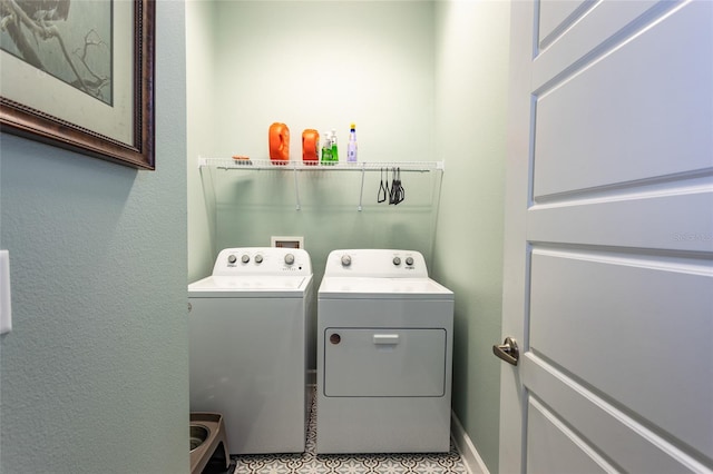 washroom with independent washer and dryer and light tile patterned flooring