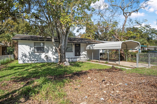 view of front of home with a front yard and a carport