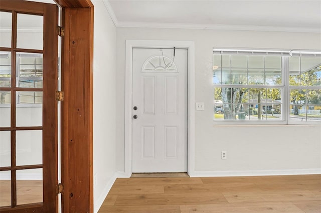 entryway featuring light wood-type flooring and ornamental molding