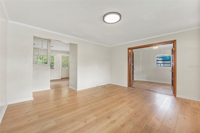 spare room featuring light hardwood / wood-style floors and crown molding