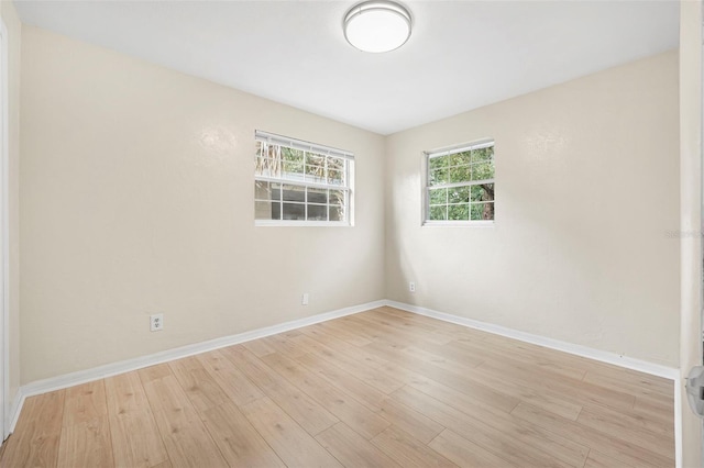 spare room with light wood-type flooring