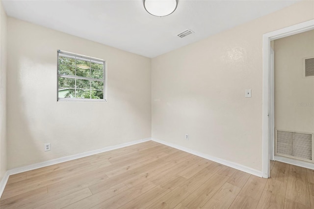 empty room with light hardwood / wood-style flooring