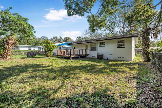 back of property featuring a lawn, central AC, and a deck